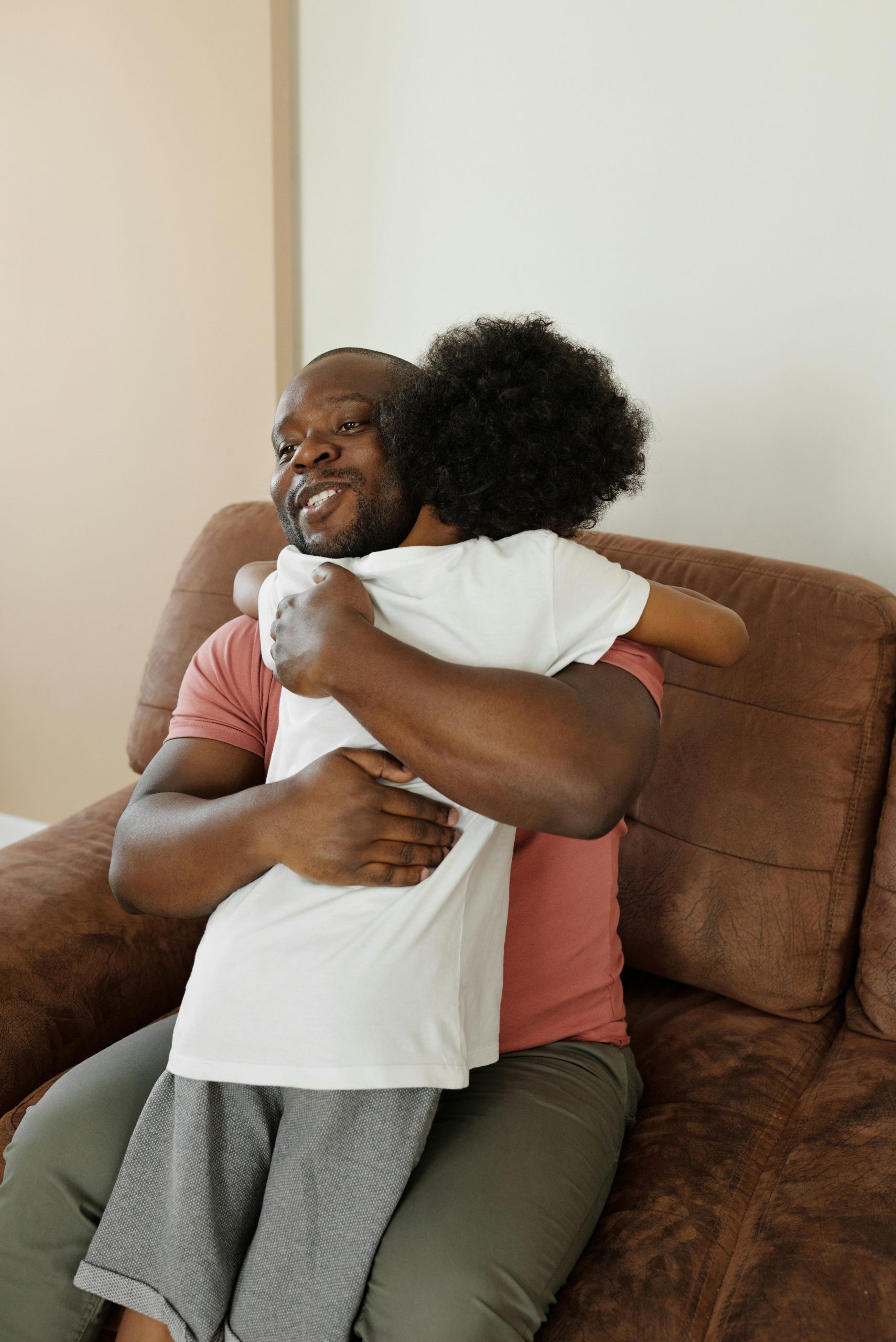 Child hugging an elderly relative in a care home