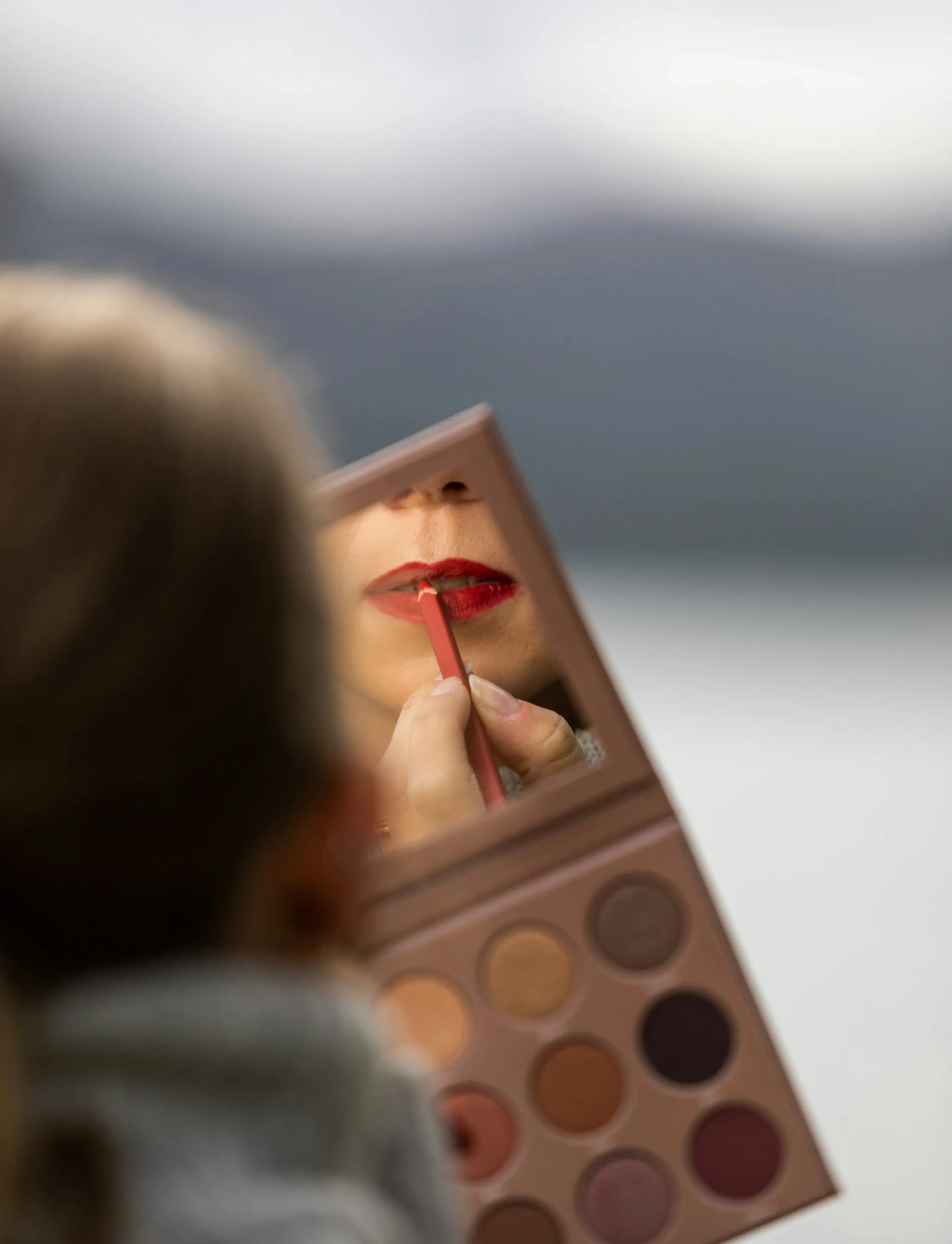 Stronger together: Building cohesion in the care home sector 3 Close-up of person looking in a mirror applying lipstick