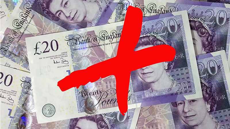 Pile of bank notes with a big graffiti red X stamped on top