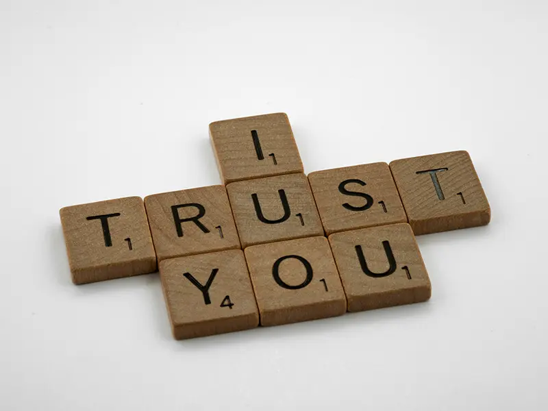 Scrabble tiles spelling out ‘I Trust You’